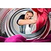 Housework: young woman doing laundry (shallow DOF; color toned image)