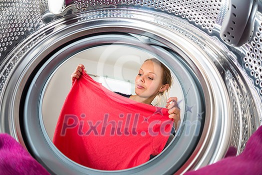Housework: young woman doing laundry (shallow DOF; color toned image) Housework: young woman doing laundry (shallow DOF; color toned image)