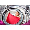 Housework: young woman doing laundry (shallow DOF; color toned image)