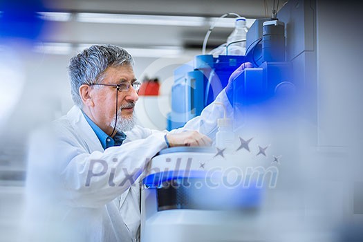 Senior male researcher carrying out scientific research in a lab (shallow DOF; color toned image) Senior male researcher carrying out scientific research in a lab (shallow DOF; color toned image)