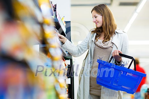 Beautiful young woman shopping in a grocery store/supermarket (color toned image) Beautiful young woman shopping in a grocery store/supermarket (color toned image)