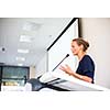 Pretty young business woman giving a presentation in a conference/meeting setting (shallow DOF; color toned image)