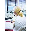 Portrait of a female researcher doing research in a lab (shallow DOF; color toned image)