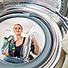 Housework: young woman doing laundry (shallow DOF; color toned image)