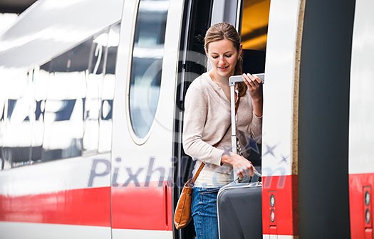 Pretty young woman boarding a train Pretty young woman boarding a train