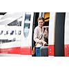 Pretty young woman boarding a train