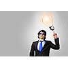 Image of young businessman with light bulb. New idea and inspiration