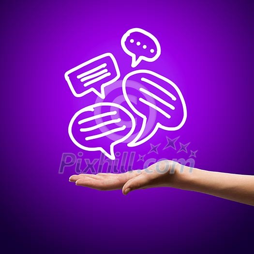 Close up image of human hand holding speech bubbles Close up image of human hand holding speech bubbles