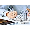 Image of businesswoman sitting at table and drawing sketch