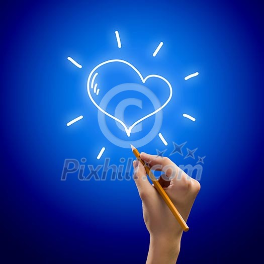 Close up image of human hand drawing heart Close up image of human hand drawing heart