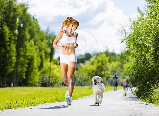 Young attractive sport girl running with dog in park Young attractive sport girl running with dog in park
