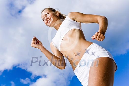 Bottom view of sport girl in white wear running Bottom view of sport girl in white wear running