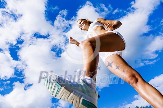Bottom view of sport girl in white wear running Bottom view of sport girl in white wear running