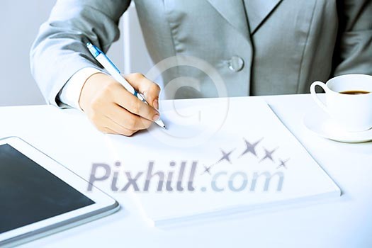 Close up image of businesswoman hands signing documents Close up image of businesswoman hands signing documents
