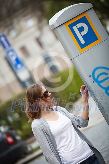 Young woman paying for parking Young woman paying for parking