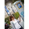 Young woman paying for parking