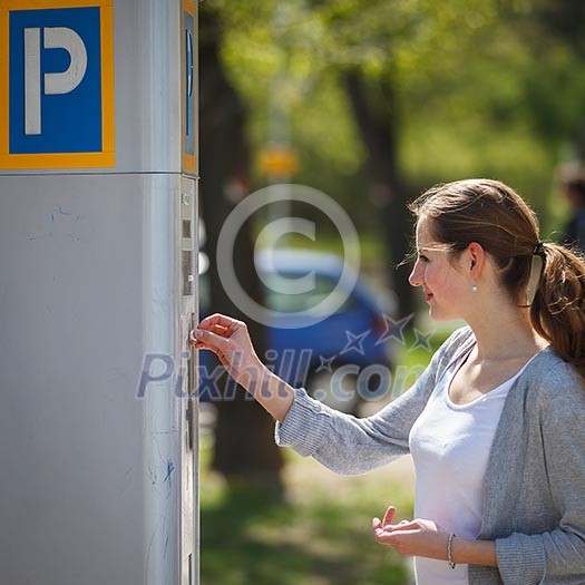 Young woman paying for parking Young woman paying for parking