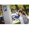 Young woman paying for parking