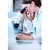 Portrait of a female researcher carrying out research in a chemistry lab (color toned image; shallow DOF)