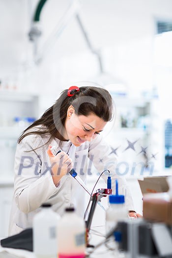 Portrait of a female researcher doing research in a lab (shallow DOF; color toned image) Portrait of a female researcher doing research in a lab (shallow DOF; color toned image)