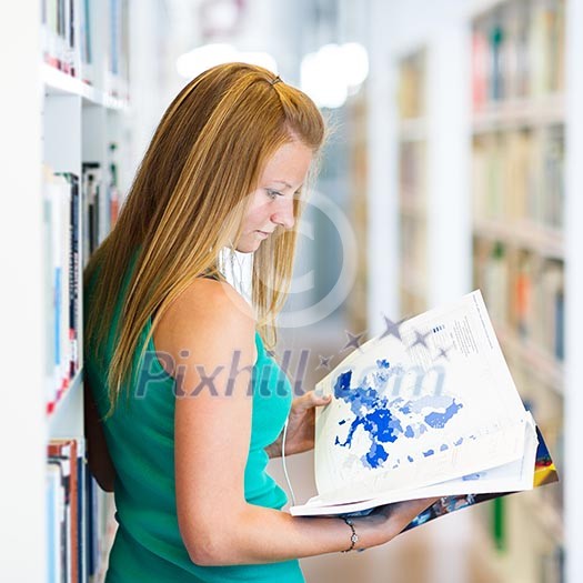 pretty young college student in a library (shallow DOF; color toned image) pretty young college student in a library (shallow DOF; color toned image)