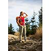 Pretty, female hiker going downhill in warm evening light