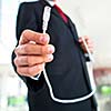 Young businessman holding an ethernet cable - stressing the importance of fast and reliable internet connection for a business (color toned image; shallow DOF)