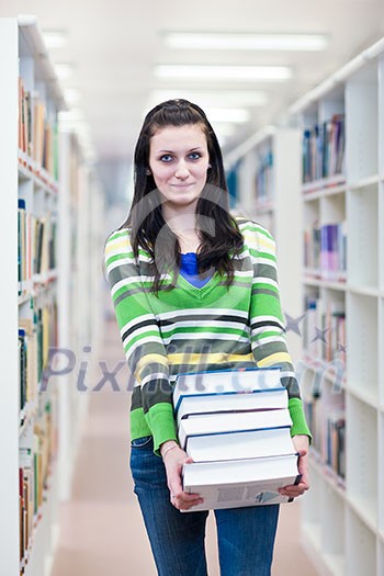 In the library - pretty, female student searching for books in a high school/university library (color toned image) In the library - pretty, female student searching for books in a high school/university library (color toned image)
