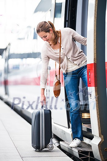 Pretty young woman boarding a train (color toned image) Pretty young woman boarding a train (color toned image)