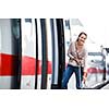 Pretty young woman boarding a train