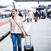 Pretty young woman at a train station (color toned image)