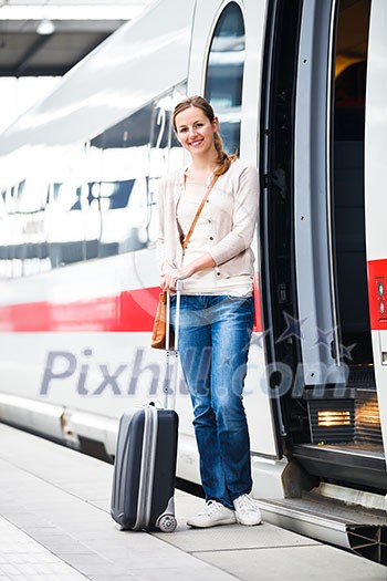 Pretty young woman boarding a train (color toned image) Pretty young woman boarding a train (color toned image)