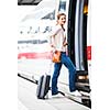 Pretty young woman boarding a train (color toned image)
