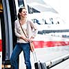 Pretty young woman boarding a train