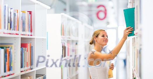pretty young college student in a library (shallow DOF; color toned image) pretty young college student in a library (shallow DOF; color toned image)