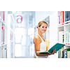 Pretty young college student in a library (shallow DOF; color toned image)