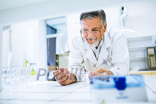 Senior male researcher carrying out scientific research in a lab (shallow DOF; color toned image) Senior male researcher carrying out scientific research in a lab (shallow DOF; color toned image)