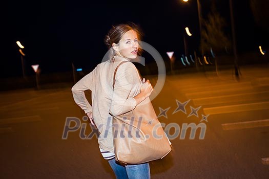 Scared young woman running from her pursuer in a deserted parking lot Scared young woman running from her pursuer in a deserted parking lot