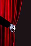 Close up of hand in white glove open the curtain. Place for text