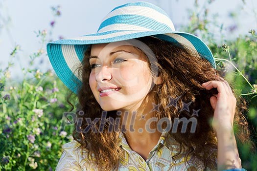 Young beautiful girl in hat and glasses sitting in grass Young beautiful girl in hat and glasses sitting in grass