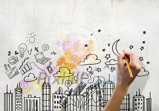 Close up image of human hand drawing sketches of city Close up image of human hand drawing sketches of city