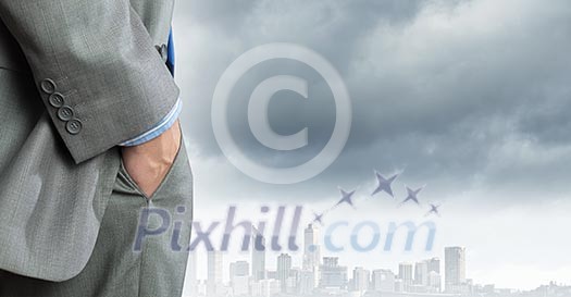 Bottom view of businessman against city background Bottom view of businessman against city background