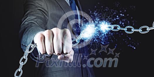 Powerful businessman holding chain in his fist Powerful businessman holding chain in his fist