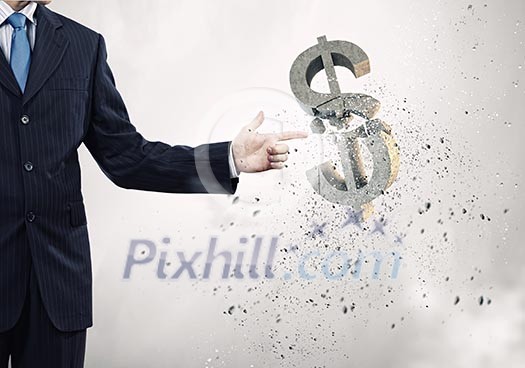 Businessman breaking dollar stone symbol with finger touch Businessman breaking dollar stone symbol with finger touch