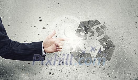 Businessman breaking recycle stone symbol with finger Businessman breaking recycle stone symbol with finger