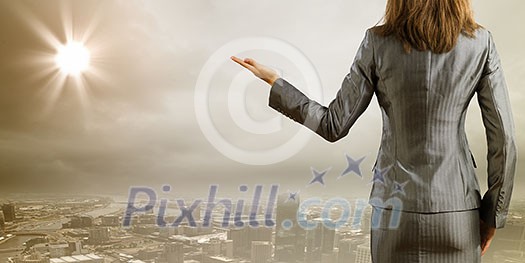 Back view of businesswoman against big city scene Back view of businesswoman against big city scene
