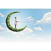 Little girl standing on moon and fishing