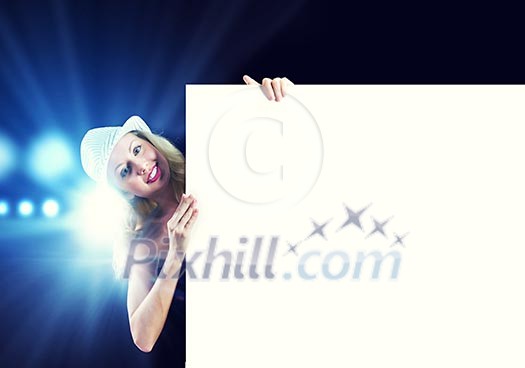 Girl standing behind white blank banner. Place for text Girl standing behind white blank banner. Place for text