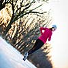 Young woman running outdoors on a cold winter day