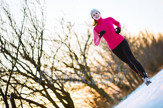 Young woman running outdoors on a cold winter day Young woman running outdoors on a cold winter day